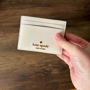 kate spade cream card case with gold logo